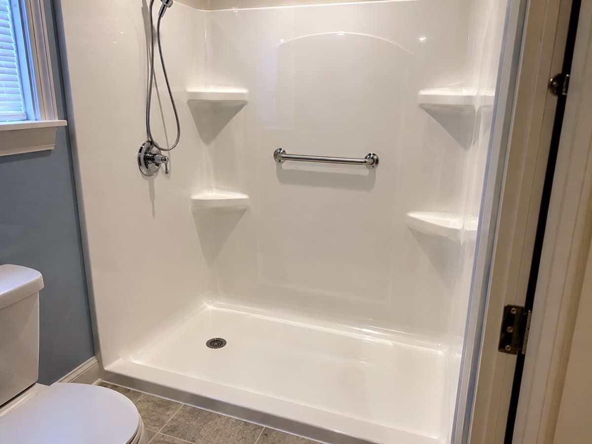 Shower surround restored to a like-new finish through professional glazing rather than replacement — Indiana Flow