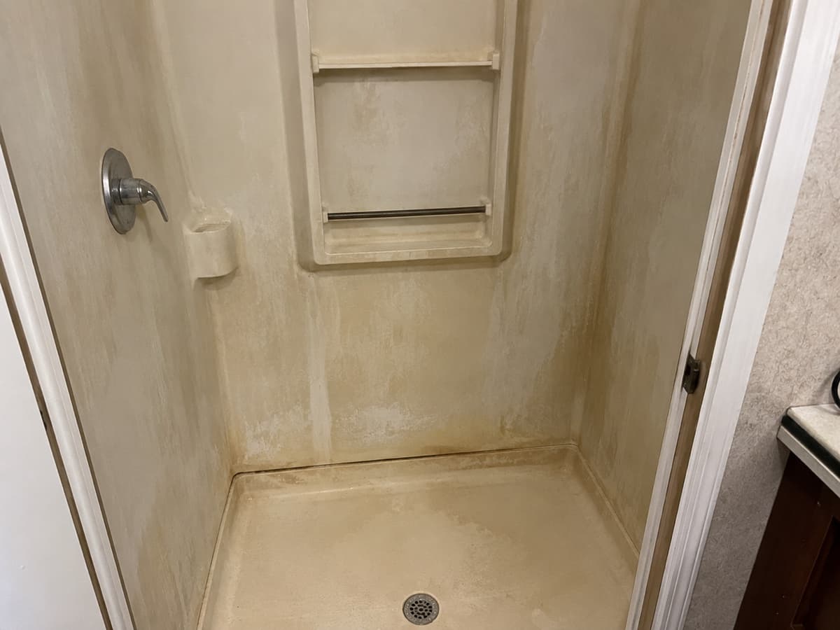 Shower before professional glazing — stained fiberglass in Indianapolis
